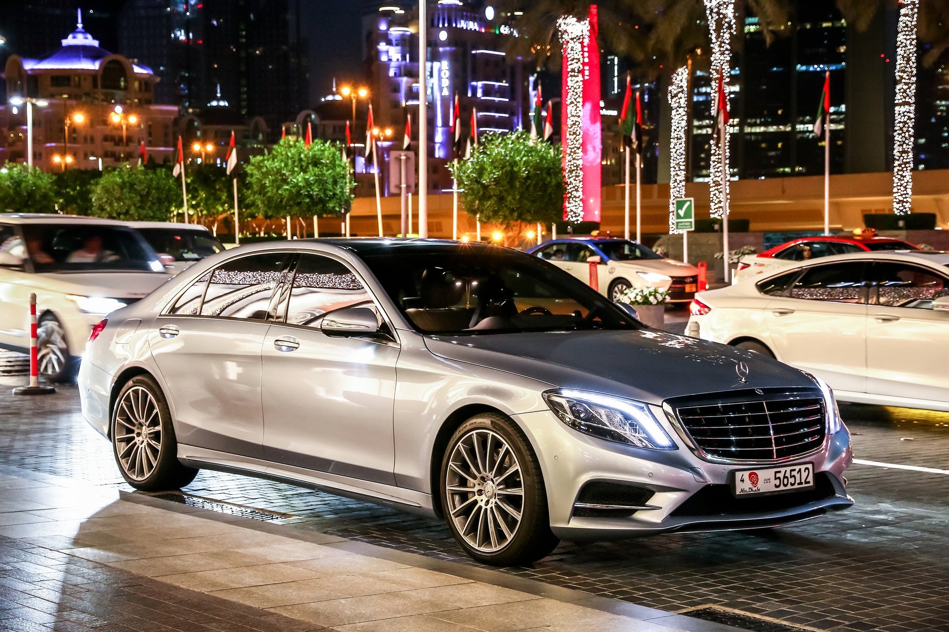 Dubai, UAE - November 18, 2018: Luxury motor car Mercedes-Benz W222 S-class in the night city street.