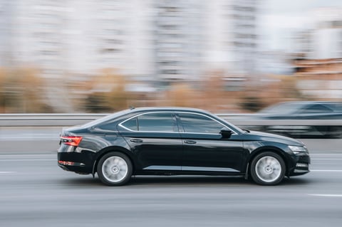 Ukraine, Kyiv - 23 November 2021: Black Skoda Superb car moving on the street. Editorial