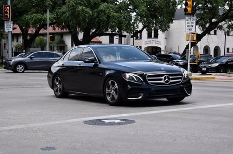 Houston, TX USA 4-18-2025 -  A black Mercedes-Benz E-Class S Class sedan, turns ahead of competitors, near Hermann Park in the downtown financial district.
